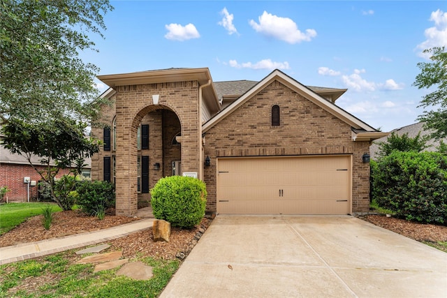 traditional-style home with an attached garage, driveway, and brick siding