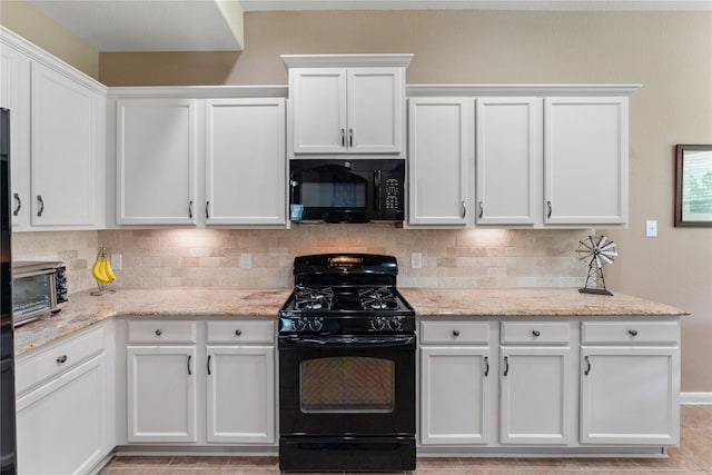 kitchen with white cabinets, a toaster, decorative backsplash, and black appliances