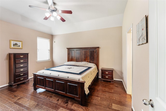 bedroom with baseboards, a ceiling fan, and dark wood-style floors