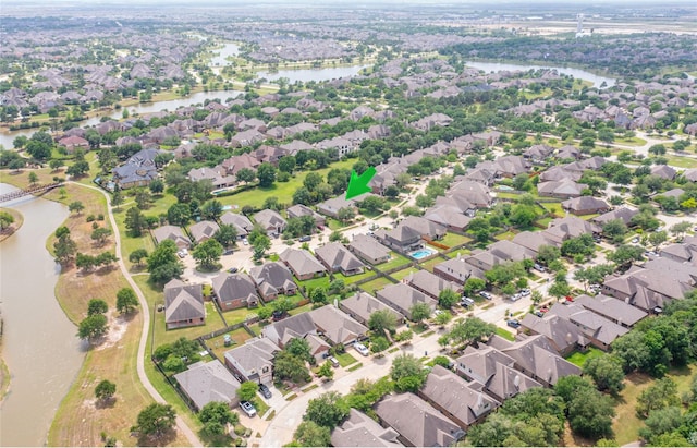 drone / aerial view featuring a residential view and a water view