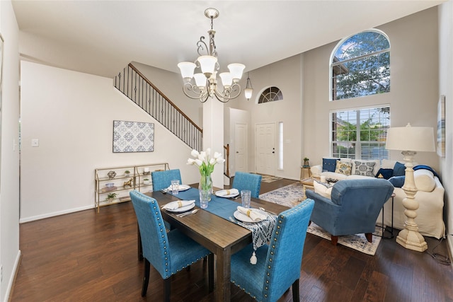 18823 Cove Mill Ln, Cypress, TX 77433 - dining area featuring a chandelier, wood finished floors, a towering ceiling, and stairs