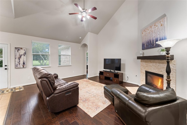 18823 Cove Mill Ln, Cypress, TX 77433 - living area featuring high vaulted ceiling, dark wood-style flooring, a ceiling fan, a stone fireplace, and arched walkways