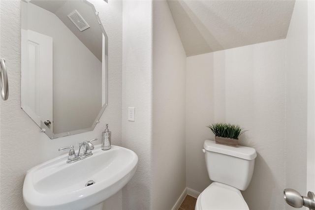 18823 Cove Mill Ln, Cypress, TX 77433 - half bathroom featuring a sink and lofted ceiling