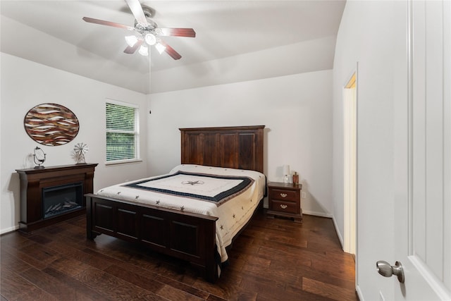 18823 Cove Mill Ln, Cypress, TX 77433 - bedroom with dark wood-style floors, a ceiling fan, and a glass covered fireplace