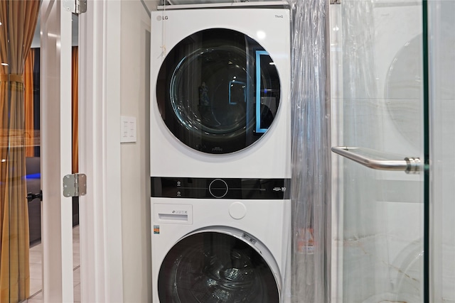 laundry room with stacked washer and clothes dryer and laundry area