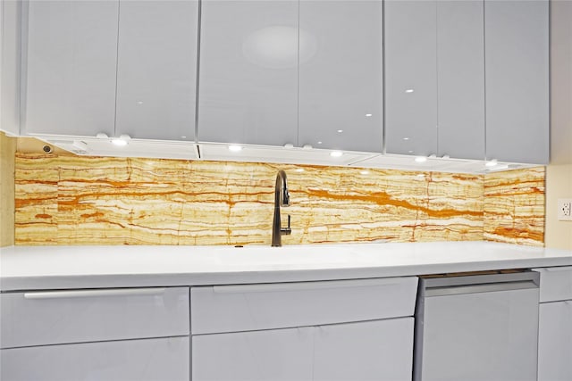 interior space featuring light countertops, white dishwasher, white cabinetry, and modern cabinets