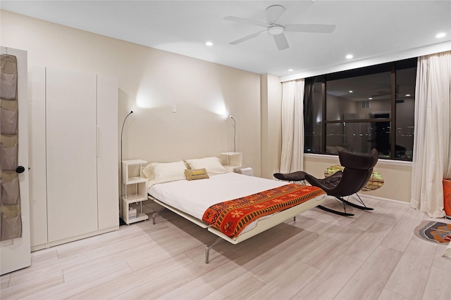 bedroom with recessed lighting, a ceiling fan, and light wood-style flooring
