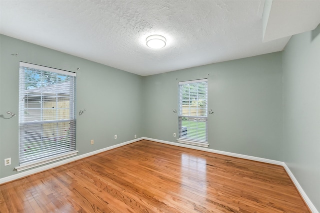 302 Hickory Ridge Dr, El Lago, TX 77586 - empty room with a textured ceiling, wood finished floors, and baseboards
