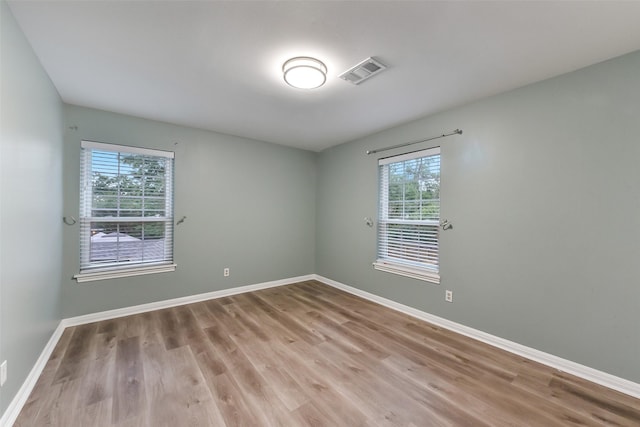 302 Hickory Ridge Dr, El Lago, TX 77586 - empty room featuring baseboards, visible vents, light wood-style floors, and plenty of natural light