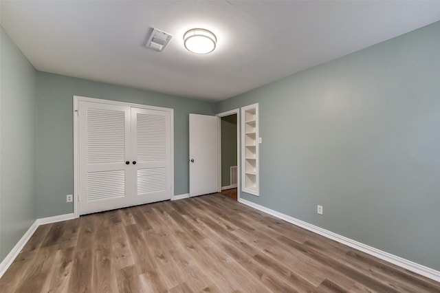 302 Hickory Ridge Dr, El Lago, TX 77586 - unfurnished bedroom featuring baseboards, visible vents, wood finished floors, and a closet