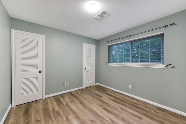 302 Hickory Ridge Dr, El Lago, TX 77586 - unfurnished bedroom with visible vents, light wood-style flooring, and baseboards