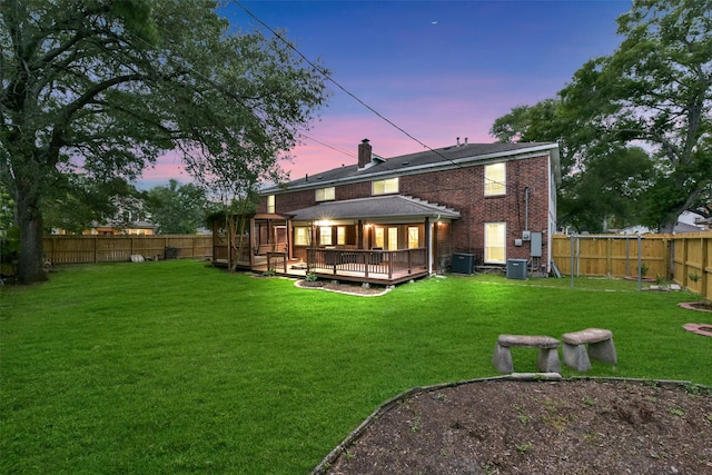302 Hickory Ridge Dr, El Lago, TX 77586 - rear view of property with a lawn, a wooden deck, central AC, and a fenced backyard
