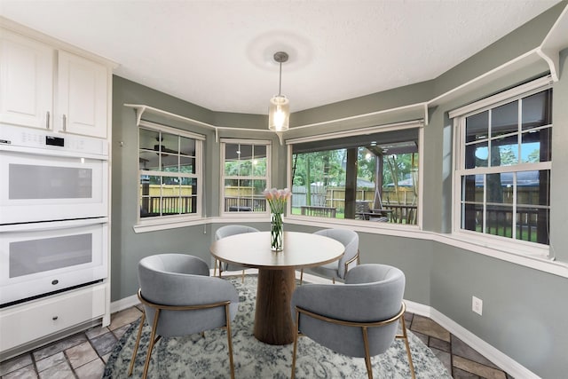 302 Hickory Ridge Dr, El Lago, TX 77586 - dining space featuring stone tile flooring and baseboards