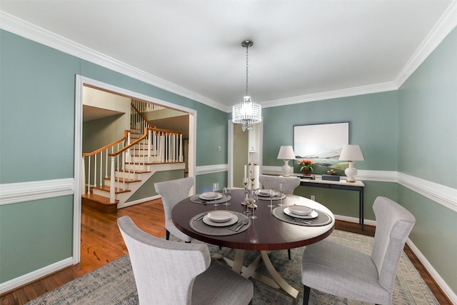 302 Hickory Ridge Dr, El Lago, TX 77586 - dining room with wood finished floors, a notable chandelier, stairs, and ornamental molding