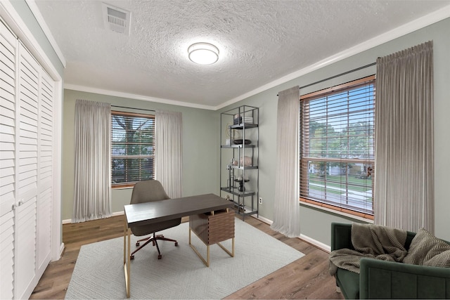 302 Hickory Ridge Dr, El Lago, TX 77586 - office area featuring wood finished floors, visible vents, a textured ceiling, and baseboards
