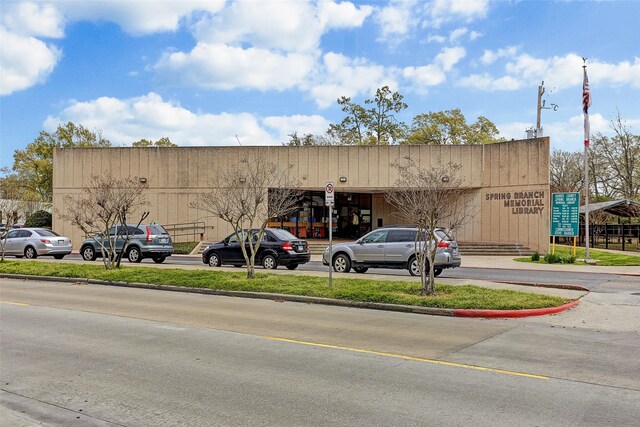 view of building exterior with uncovered parking