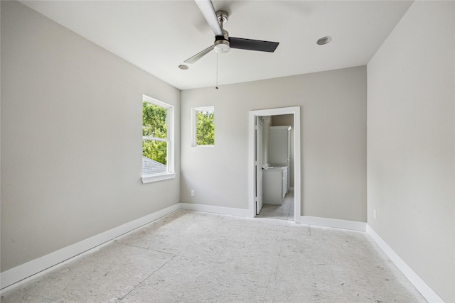 unfurnished bedroom with baseboards, ceiling fan, and connected bathroom