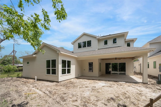 rear view of property with a patio area, roof with shingles, and ceiling fan