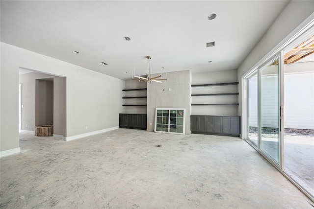 unfurnished living room featuring concrete floors and baseboards