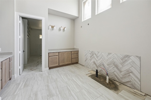 bathroom featuring a high ceiling and vanity