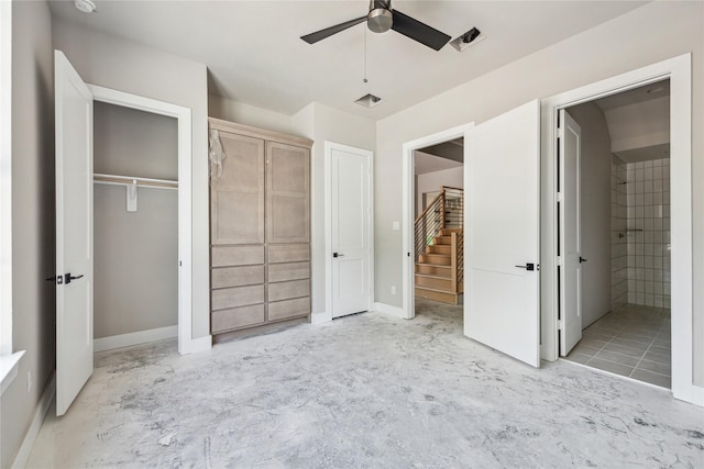 unfurnished bedroom with two closets, ceiling fan, ensuite bath, and visible vents