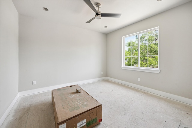 spare room featuring baseboards and a ceiling fan