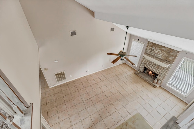 906 N Chamfer Way, Crosby, TX 77532 - unfurnished living room featuring ceiling fan, tile patterned floors, a stone fireplace, and visible vents