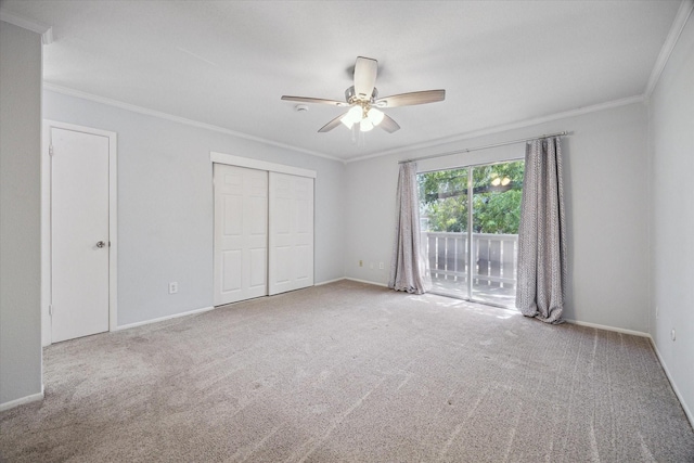 unfurnished bedroom with baseboards, ornamental molding, carpet flooring, and access to exterior
