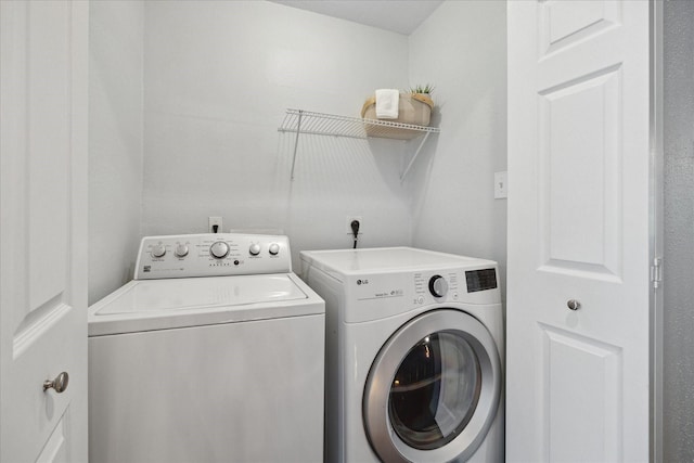 washroom with laundry area and separate washer and dryer