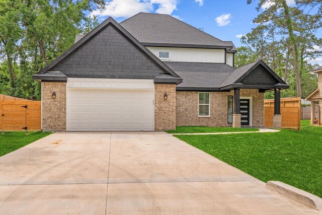 view of front facade with driveway, brick siding, fence, a front lawn, and an attached garage