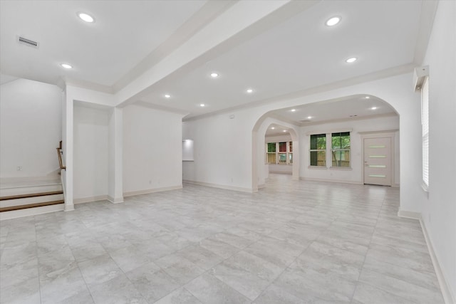 unfurnished living room featuring visible vents, arched walkways, baseboards, and recessed lighting
