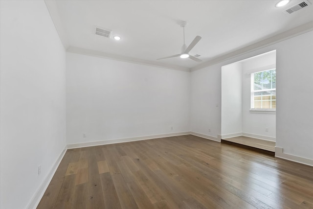 unfurnished room featuring visible vents, a ceiling fan, and wood-type flooring