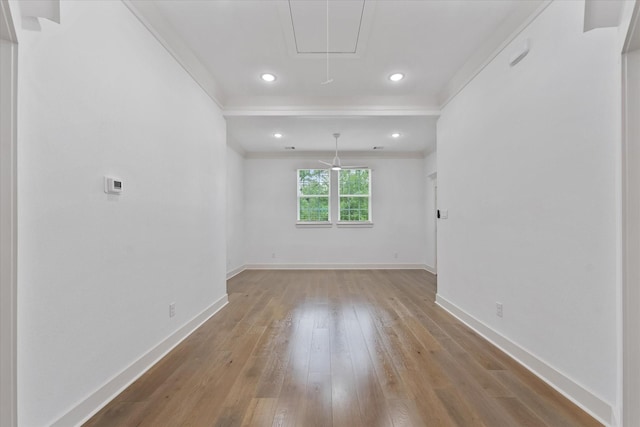 spare room featuring recessed lighting, baseboards, attic access, and light wood finished floors