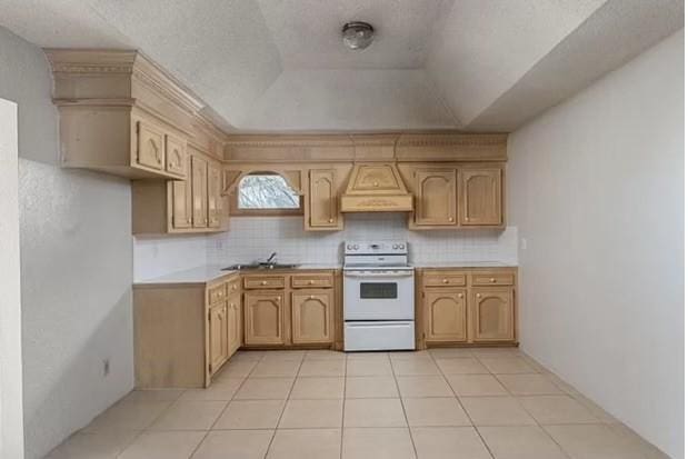 kitchen featuring a sink, white electric stove, custom exhaust hood, and light countertops