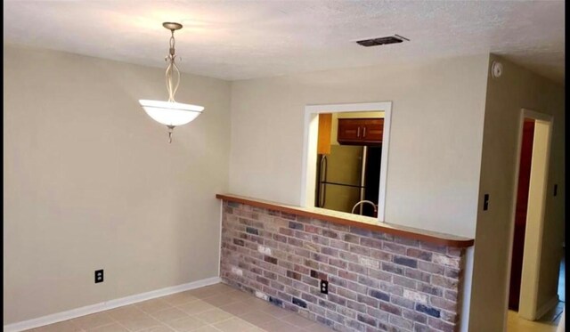 10666 Hazelhurst Dr Unit 22, Houston, TX 77043 - empty room featuring baseboards, light tile patterned flooring, and visible vents