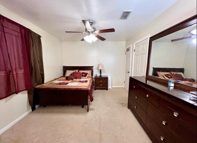10666 Hazelhurst Dr Unit 22, Houston, TX 77043 - bedroom featuring baseboards, visible vents, a ceiling fan, and light colored carpet