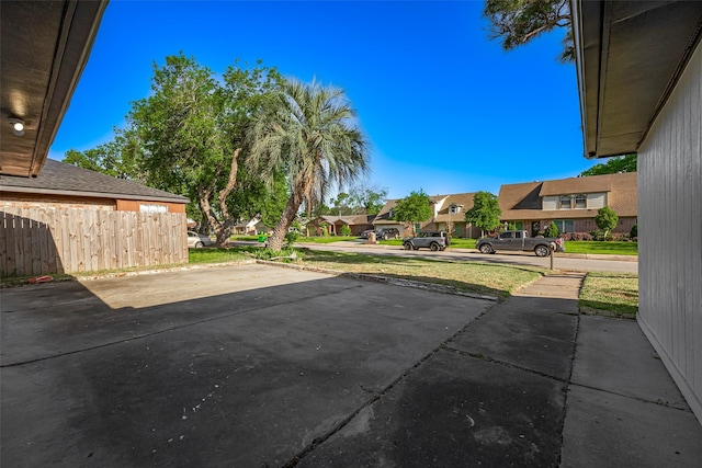 view of patio / terrace with fence and a residential view