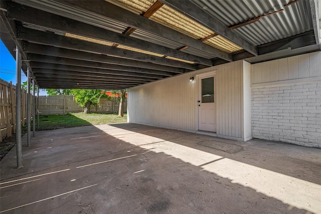 view of patio featuring fence and an attached carport