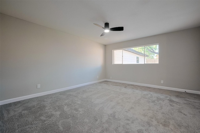 unfurnished room with baseboards, a ceiling fan, and carpet