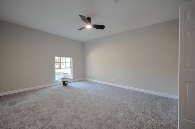 carpeted empty room with a ceiling fan and baseboards