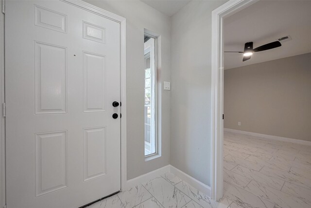 foyer with marble finish floor, baseboards, and a ceiling fan