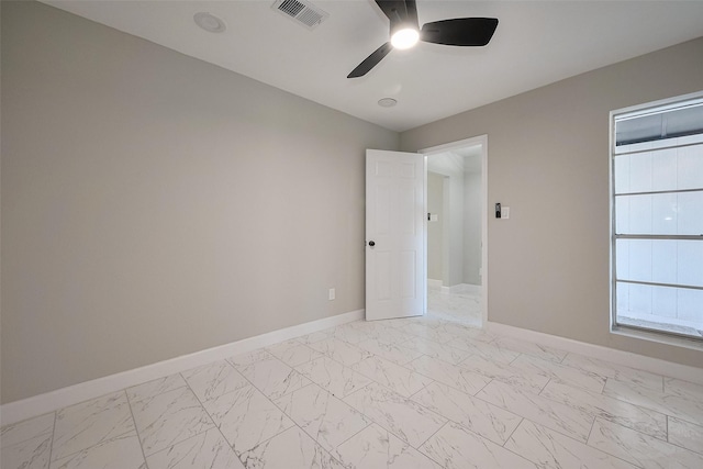 unfurnished room featuring baseboards, visible vents, marble finish floor, and ceiling fan