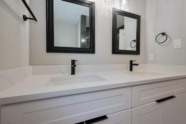full bath featuring a sink and double vanity