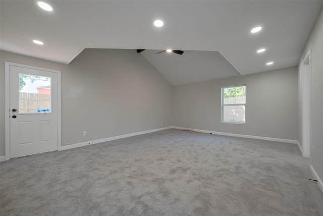 unfurnished room featuring lofted ceiling, carpet floors, baseboards, and recessed lighting
