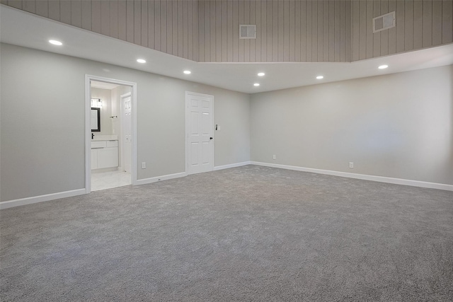 spare room featuring carpet flooring, visible vents, and recessed lighting