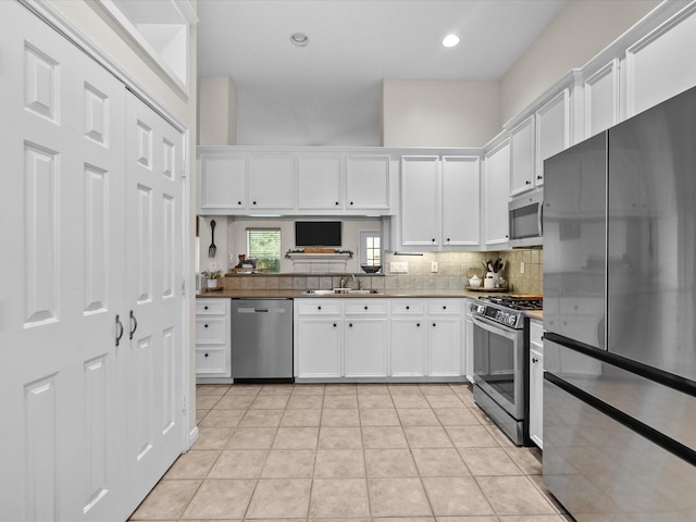 kitchen featuring white cabinetry, stainless steel appliances, and a sink