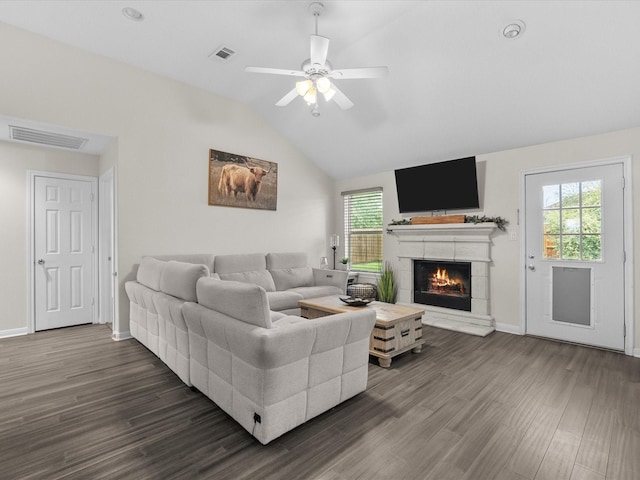 living area featuring visible vents, a wealth of natural light, and dark wood-style flooring