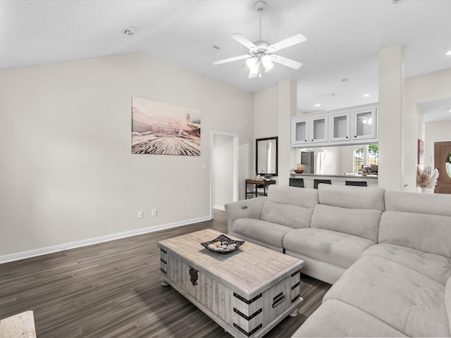 living room featuring vaulted ceiling, ceiling fan, baseboards, dark wood-type flooring, and recessed lighting
