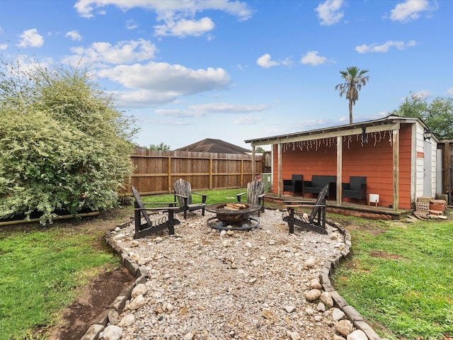 view of yard featuring a fire pit and fence