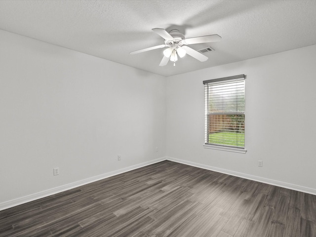 empty room with ceiling fan, dark wood-style flooring, a textured ceiling, and visible vents